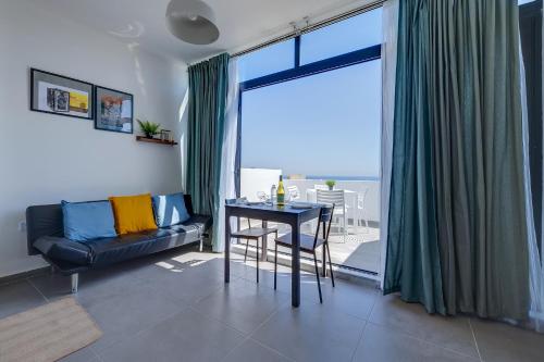a living room with a table and a couch at Sliema Creek Suites in Sliema