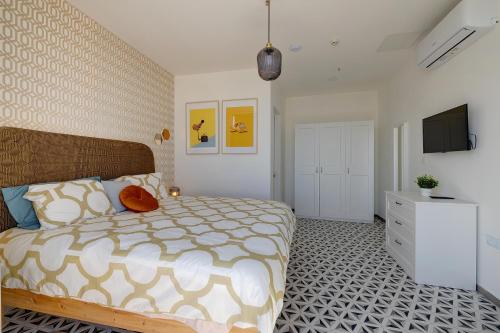 a bedroom with a bed and a television in it at Sliema Creek Suites in Sliema
