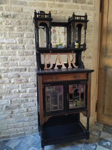 a wooden table with a bar sign on top of it at chambres d'hôtes Le Carillon in Bergues