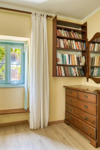a bedroom with a window and a dresser and a book shelf at Kazanegra Exclusive Apartments in Sveti Stefan