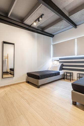 a bedroom with a bed and a mirror on the wall at Ermoo Athens Modern Living in Athens
