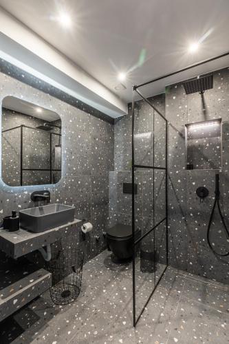 a bathroom with a toilet and a sink and a shower at Ermoo Athens Modern Living in Athens