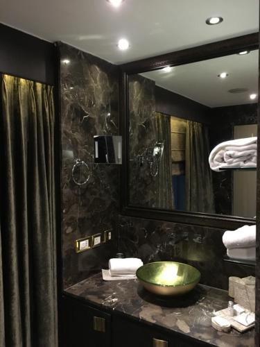 a bathroom with a green sink and a mirror at Radisson Blu Hotel MBD Ludhiana in Ludhiana