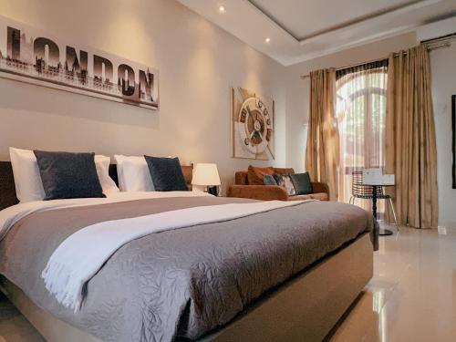 a bedroom with a large bed and a living room at IL-Gardjola Bed and Breakfast in Għarb
