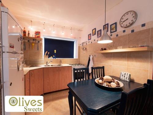 a kitchen with a table and a dining room at Olives sweets in Arad