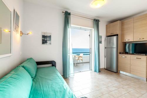 a bedroom with a bed and a view of the ocean at Glyfada New Era Home 120 Menigos Resort Apartments in Glyfada