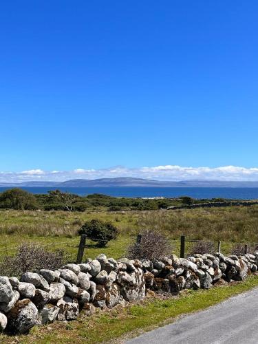 a stone wall on the side of a road at Wild Atlantic Stay Cottage in Galway