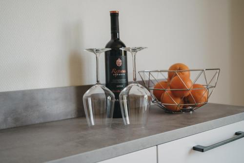 a bottle of wine and two glasses on a counter at Ferienhaus Heimathafen am Diemelsee, Willingen, Winterberg in Diemelsee