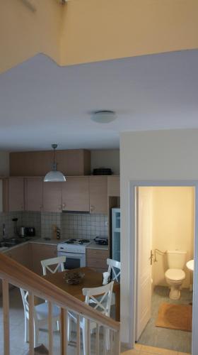 a kitchen with a table and chairs and a sink at EOΣ in Nikiana