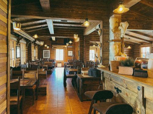 a dining room with wooden tables and chairs at Villas Jagoda & Malina in Borovets