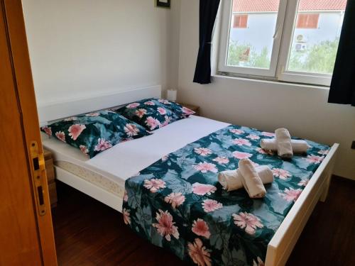 a bedroom with a bed with two stuffed animals on it at Villa Vesna in Preko