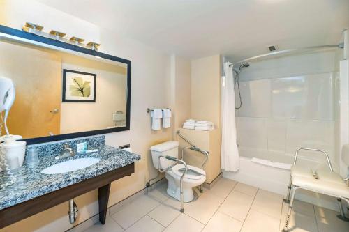 a bathroom with a sink and a toilet and a shower at Prestige Riverside Lodge Quesnel in Quesnel