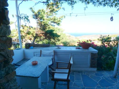 a patio with a table and chairs on a patio at Το Κατἑ in Artemonas
