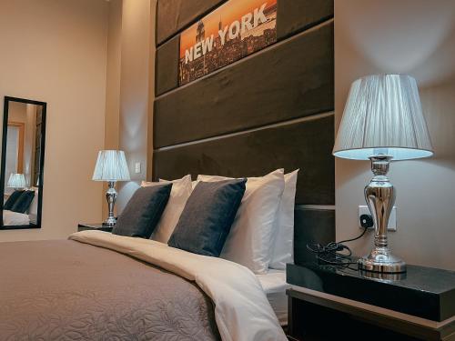 a bedroom with a bed with a large wooden headboard at IL-Gardjola Bed and Breakfast in Għarb