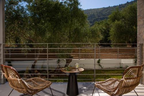 two chairs and a table on a patio at HYADES VILLAS LEFKADA in Agios Nikitas