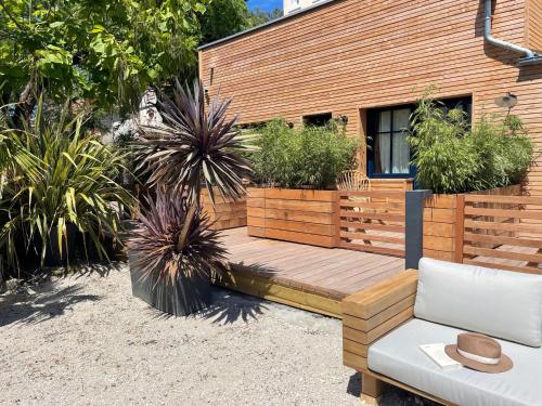 a wooden deck with potted plants on a house at Le Homard Bleu in Saint-Trojan-les-Bains