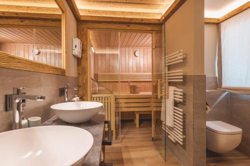 bagno con vasca, lavandino e servizi igienici di Almlodge Westendorf a Westendorf