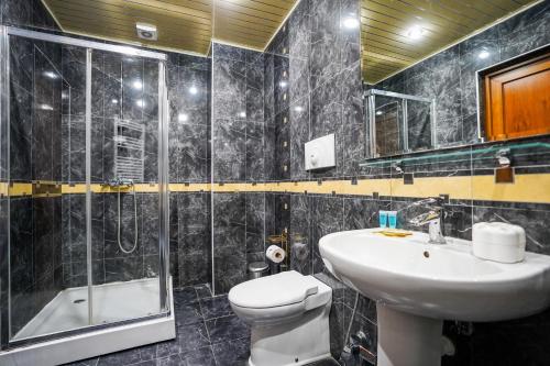 a bathroom with a sink and a toilet and a shower at Natali Hotel in Borjomi