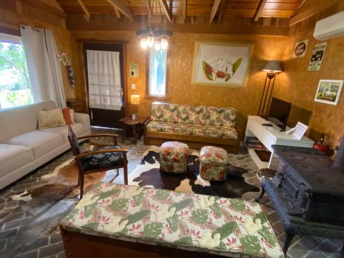 a living room with a couch and a table at Chalé Estilo Alemão - Centro de Canela in Canela