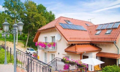 a house with solar panels on its roof at Pensjonat PANORAMA in Karpacz