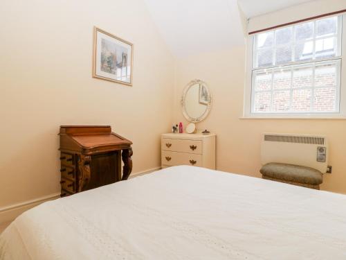 a bedroom with a white bed and a window at 138D Old Star & Garter Mews in Ludlow