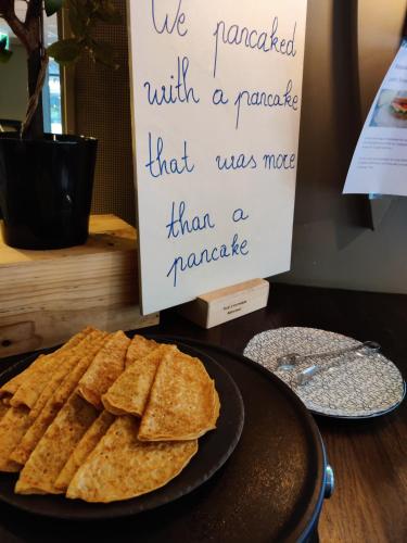 a plate of crackers on a table with a sign at First Hotel Millennium in Oslo