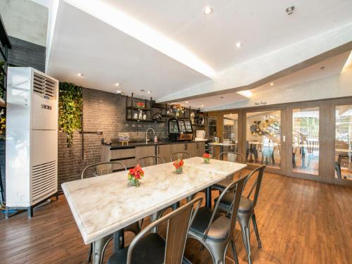 a kitchen with a large marble table and chairs at Solace Hotel in Manila