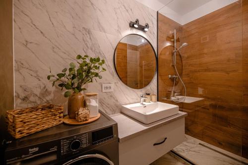 a bathroom with a sink and a mirror at ARA Apart Hotel Brasov in Braşov