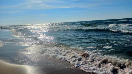 a wave breaking on the shore of the ocean at Domjana Lubiatowo in Lubiatowo