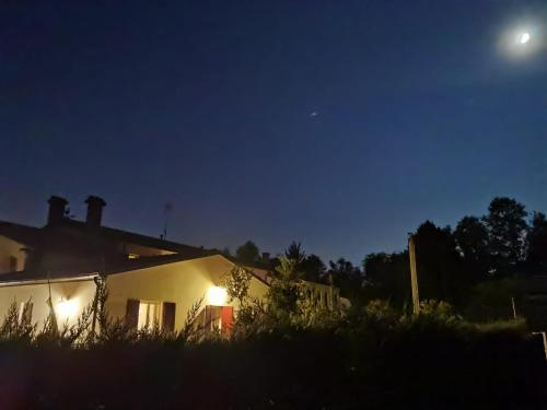 a house at night with the moon in the sky at Agriturismo Honey Farm in Piazzola sul Brenta