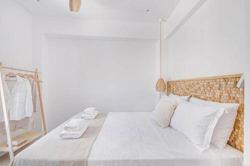 a bedroom with a bed with white sheets and white pillows at Pearl House - Luxurious new beach villa in Spetses stunning view in Spetses