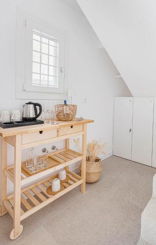 a kitchen with a table with glasses on it at Pearl House - Luxurious new beach villa in Spetses stunning view in Spetses
