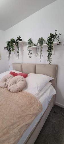a bedroom with a bed with plants on the wall at Apartament w centrum Premium in Ustrzyki Dolne