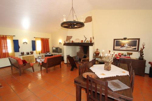 a living room with a table and a dining room at Cerca da Ponte in Almodôvar