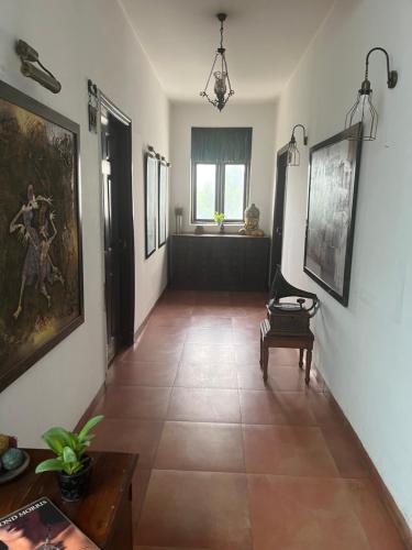 a hallway with a painting on the wall and a table at House of Kapaali in Greater Noida