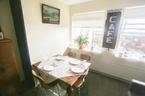 a dining room table with four chairs and a window at Villa apartment Hafnarfjordur - Ideal for Aurora in Hafnarfjördur