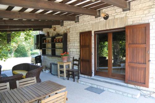 a patio with a wooden door and a table and chairs at Casa La Gorga in Cagli