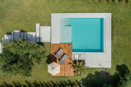 an overhead view of a swimming pool and a house at Luria Homes in Lagomandra