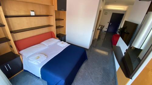 Un pequeño dormitorio con una cama azul en una habitación en Blu Residence - Hotel nel Salento, en Casarano