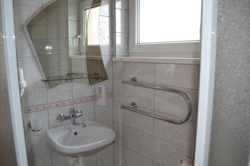 a bathroom with a sink and a mirror at Mariu Krantas in Nida