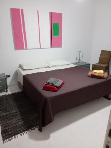 a bedroom with a bed and a chair in it at Casa Vacanze La Tonnara in San Giorgio