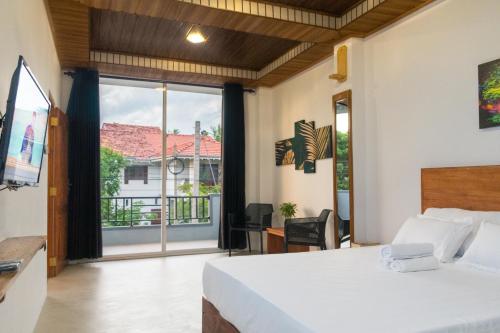 a bedroom with a bed and a large window at Western sky in Negombo