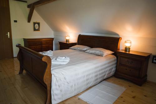 a bedroom with a large bed with two night stands at Country House Sveta Ana in Stari Trg pri Ložu