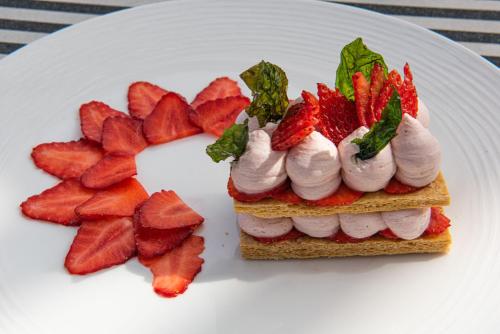 a sandwich with whipped cream and strawberries on a plate at Tribe Carcassonne in Carcassonne