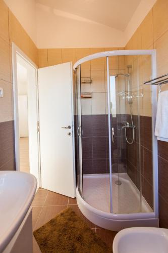 a bathroom with a shower and a toilet and a sink at Villa Veglia in Krk