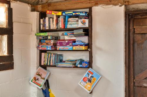 a book shelf on a wall with books at Finest Retreats - Oak Lotus Belle Tent in Ilfracombe