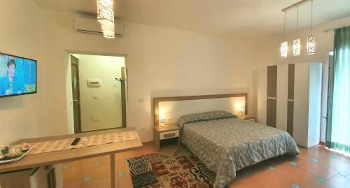 a bedroom with a bed and a large mirror at Villa Margot in Agropoli