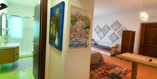 a room with a bathroom with a sink and a table at Villa Margot in Agropoli