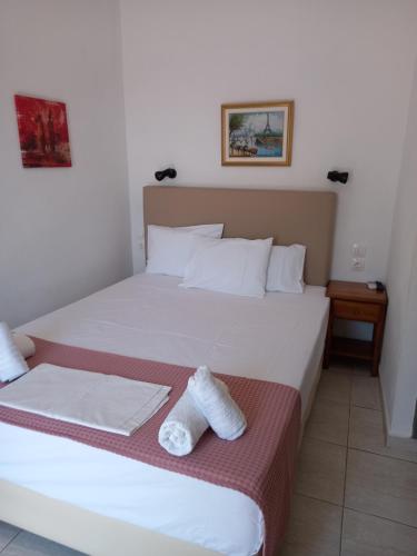 a bedroom with a bed with two towels on it at View Port in Skiathos Town