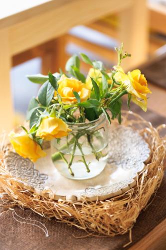 a vase filled with yellow flowers on a table at Apartman Barka in Golubac